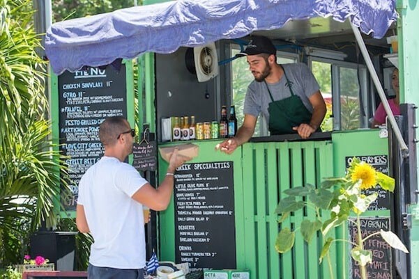 Man Buying a Drink from Local Cart