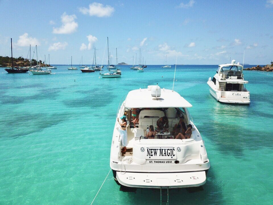 A boat sitting on the sea with a group of people on it