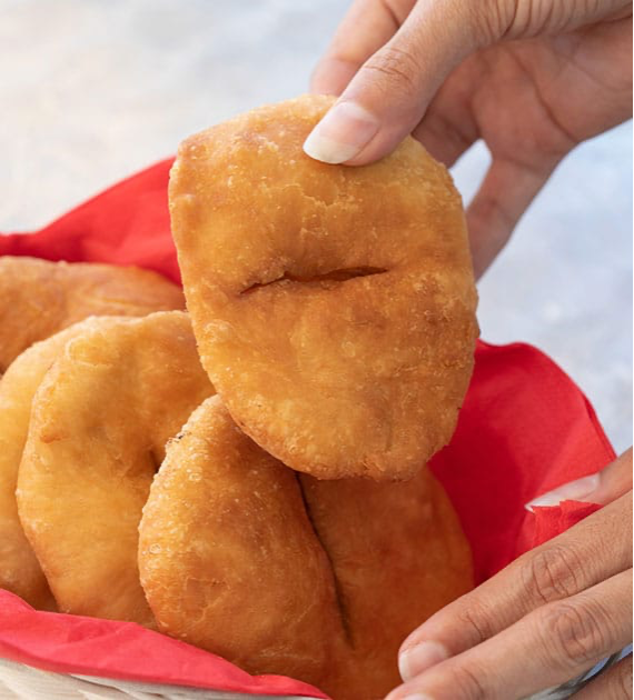 A person holding a johnny cake